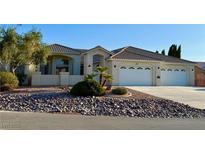 Stunning single-story home with a three-car garage and desert landscaping at 5451 Fernwood Ct, Pahrump, NV 89061