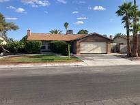 Charming single-story home with a well-maintained front yard and an attached two-car garage at 5821 Santa Catalina Ave, Las Vegas, NV 89108