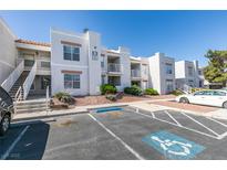 Well-maintained condo building features stucco walls, tile roof, and landscaped grounds at 6800 E Lake Mead Blvd # 1034, Las Vegas, NV 89156