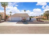 Charming single-story home with desert landscaping, tile roof, and two-car garage at 765 Butternut Ct, Henderson, NV 89014