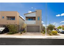 Modern two-story home featuring a neutral color palette, a two-car garage, and simple landscaping against a bright blue sky at 7777 Vino Vranec Ct, Las Vegas, NV 89113