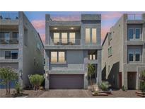 Modern three-story home featuring stucco, balconies, garage, and low-maintenance landscaping at 8042 Misty Canyon Ave, Las Vegas, NV 89113