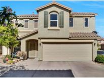 Two-story home featuring a large, attached two-car garage and desert-friendly landscaping at 8754 Brindisi Park Ave, Las Vegas, NV 89148