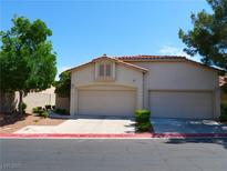 Charming home featuring a two-car garage, red tile roof, and desert-friendly landscaping at 9705 Templemore Ave # 102, Las Vegas, NV 89129