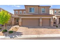 Charming two-story home features a two-car garage and well-manicured front yard at 10101 Heron Lake Ave, Las Vegas, NV 89178