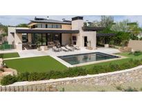 Modern home featuring a rectangular pool, outdoor seating, and an outdoor kitchen perfect for entertaining at 11707 Discovery Canyon Dr, Las Vegas, NV 89135