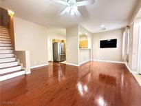 Spacious living room with hardwood floors and an open floor plan to the kitchen at 1201 Dusty Creek St, Las Vegas, NV 89128