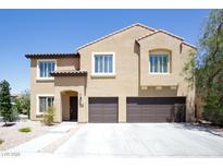 Charming two-story home boasts a two-car garage, desert landscaping, and classic architecture at 176 Jay Porter Ave, Henderson, NV 89002