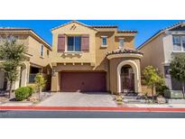 Charming two-story home featuring a red tiled roof, two-car garage, and an arched gated entrance at 1794 Morro Vista Dr, Las Vegas, NV 89135