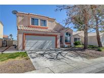 Charming two-story home with a two-car garage and beautiful landscaping under a clear blue sky at 1809 Solana Del Norte Way, North Las Vegas, NV 89031