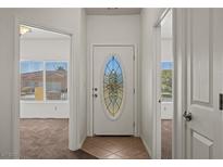 Bright entryway featuring a decorative front door and neutral color palette, creating an inviting welcome at 240 Vineyard Ln, Mesquite, NV 89027
