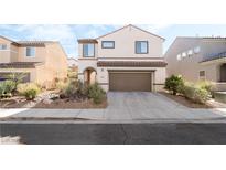 Charming two-story home featuring desert landscaping and a two-car garage at 2482 Denholme St, Henderson, NV 89044