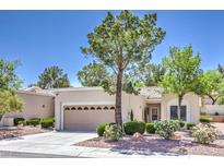 Single-story home with desert landscaping, tan stucco, and a two-car garage at 2509 Banora Point Dr, Las Vegas, NV 89134