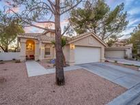 Charming single-story home with a well-manicured front yard, tile roof and a two-car garage at 2521 Seascape Dr, Las Vegas, NV 89128