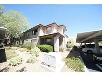 Inviting two-story home with neutral stucco, terracotta roof and carport parking at 2606 S Durango Dr # 165, Las Vegas, NV 89117