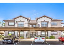 A well-maintained two-story apartment building with carports and landscaped surroundings, perfect for comfortable living at 45 Maleena Mesa St # 1321, Henderson, NV 89074