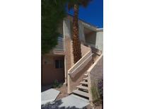 Condo building featuring stucco exterior, outdoor staircase, and mature landscaping at 5000 Red Rock St # 248, Las Vegas, NV 89118