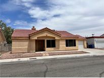 Charming single-story home with desert landscaping and a two-car garage on a sunny day at 6600 Silver Penny Ave, Las Vegas, NV 89108