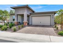 Charming single-story home featuring a welcoming entrance and a two-car garage at 676 Otter Brook St, Henderson, NV 89011