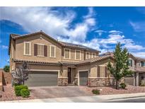 Beautiful two-story home with a three-car garage, stone accents, and well-manicured landscaping at 689 Sea Star St, Henderson, NV 89002