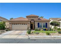 Charming single-story home featuring a desert landscape, an attached garage and a well-manicured lawn at 724 Smokey Mountain Ave, Henderson, NV 89012