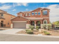 Charming two-story home featuring a two-car garage and meticulously landscaped front yard at 7316 Childers Ave, Las Vegas, NV 89178