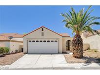 Charming one-story home with a two car garage and a mature palm tree in the front yard at 8233 Willeta Ave, Las Vegas, NV 89145