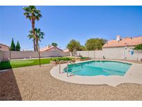 Backyard features a refreshing pool, putting green, and desert landscaping at 9817 Dardanelle Ct, Las Vegas, NV 89117