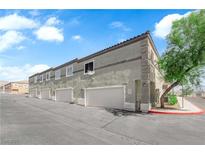 Attractive townhome featuring private garage and well-maintained landscaping at 10450 Gold Shadow Ave, Las Vegas, NV 89129