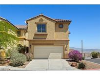 Inviting home featuring a two-car garage and well-maintained landscaping under a clear blue sky at 10650 Little Horse Creek Ave, Las Vegas, NV 89129