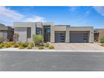 Contemporary home featuring a neutral color palette, modern design, and well-manicured landscaping at 10927 White Clay Dr, Las Vegas, NV 89135