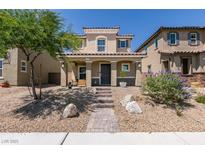 Charming two-story home with desert landscaping and a covered porch at 1130 E Dorrell Ln, North Las Vegas, NV 89086