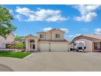 Charming two-story home features a well-manicured lawn and a spacious three-car garage at 1335 Passiflora Dr, Henderson, NV 89002