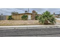 Single story home featuring a stone chimney and desert landscaping at 1607 Vegas Valley Dr, Las Vegas, NV 89169