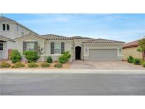 Charming single-story home featuring a two-car garage, desert landscaping, and a welcoming front porch at 2433 Amatrice St, Henderson, NV 89044