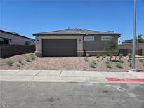 Charming single-story home featuring a two-car garage, tidy landscaping, and a well-maintained exterior at 289 Aravalli Crest St, Henderson, NV 89015