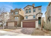 Two-story home with a two-car garage and a well-maintained, xeriscaped front yard and tile roof at 382 Gracious Way, Henderson, NV 89011