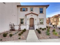 Charming two-story home with desert landscaping, covered entry, and warm exterior paint tones at 4 Lomita Heights Dr, Las Vegas, NV 89138