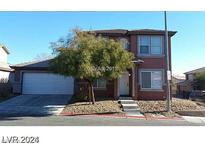 Two-story home with a two car garage, small tree and neutral colored exterior in a residential neighborhood at 5308 La Quinta Hills St, North Las Vegas, NV 89081