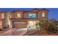 Charming two-story home boasts a well-manicured lawn, covered entry, and attached two-car garage at 5480 Oatfield St, North Las Vegas, NV 89081