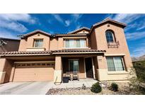Two-story stucco home with a two car garage, covered porch, and manicured landscaping at 5480 Oatfield St, North Las Vegas, NV 89081