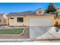 Charming single-story home featuring a tile roof, desert landscaping, and an attached two-car garage at 6143 Basilone Ave, Las Vegas, NV 89122