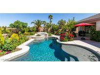 Inviting pool and spa with lush landscaping create a private backyard oasis at 8221 Bay Dunes St, Las Vegas, NV 89131