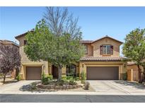 Charming two-story home featuring a well-manicured front yard and two-car garage at 9192 Moose Country Pl, Las Vegas, NV 89178