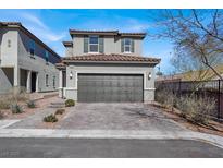 Two-story home featuring a tile roof, paired garage, and neat landscaping, presenting a well-kept exterior at 9330 Brookmont Ave, Las Vegas, NV 89149