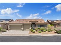 Charming single-story home features a tile roof, desert landscaping, and a spacious three-car garage at 1008 New Creek Ave, Henderson, NV 89015