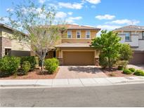 Charming two-story home featuring a paved driveway, a two-car garage and low maintenance landscaping at 10315 Turia Gardens Rd, Las Vegas, NV 89135