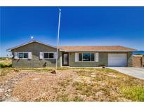 Charming single-story home featuring a well-kept yard and a one car garage at 1190 W Sierra Vista Cir, Pahrump, NV 89060