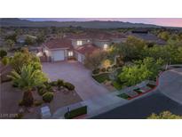 Stunning two-story home with a red tile roof, lush landscaping, and a spacious driveway at 1383 Opal Valley St, Henderson, NV 89052