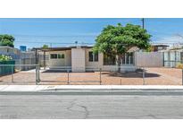 Charming single-story home with desert landscaping and chain-link fence at 1720 Eastwood Dr, Las Vegas, NV 89104